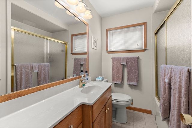 full bathroom with bath / shower combo with glass door, tile patterned floors, vanity, and toilet