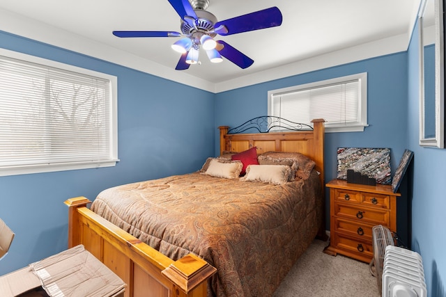 carpeted bedroom featuring ceiling fan and radiator heating unit