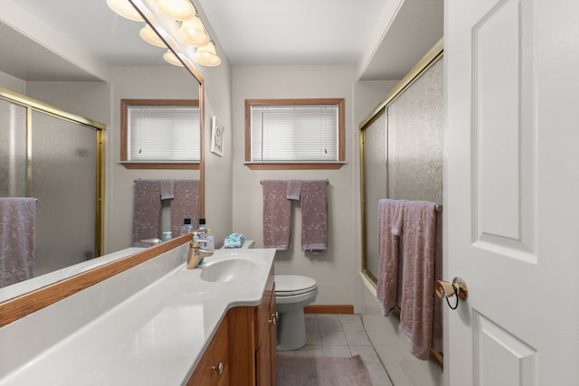 full bathroom featuring enclosed tub / shower combo, vanity, toilet, and tile patterned flooring