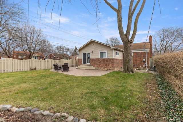 rear view of property featuring a patio area and a lawn