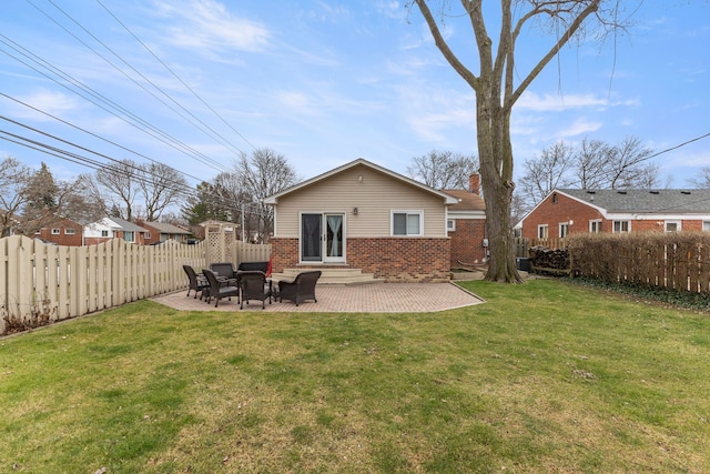 back of house with a yard and a patio