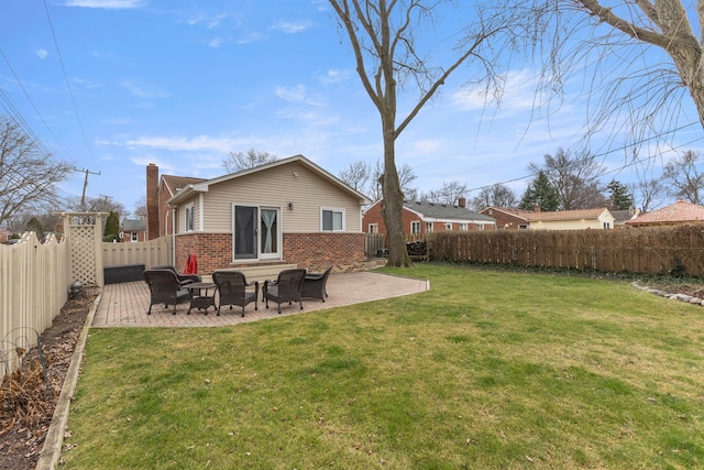 rear view of house with a yard and a patio