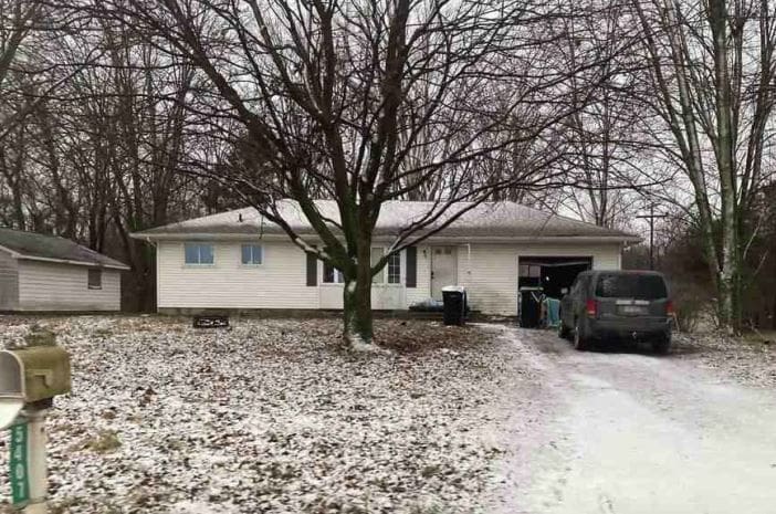 snow covered property featuring a garage