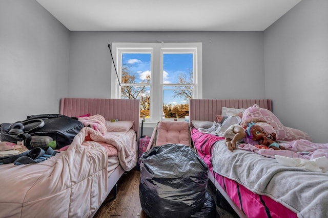 bedroom with dark hardwood / wood-style flooring and multiple windows