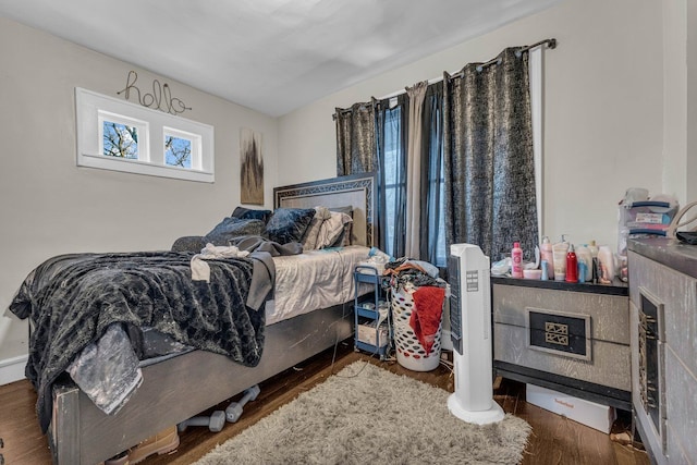 bedroom with dark wood-type flooring