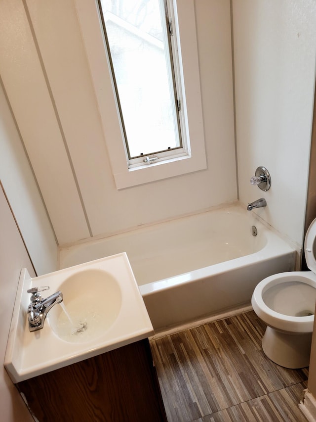 bathroom featuring wood-type flooring, vanity, and toilet