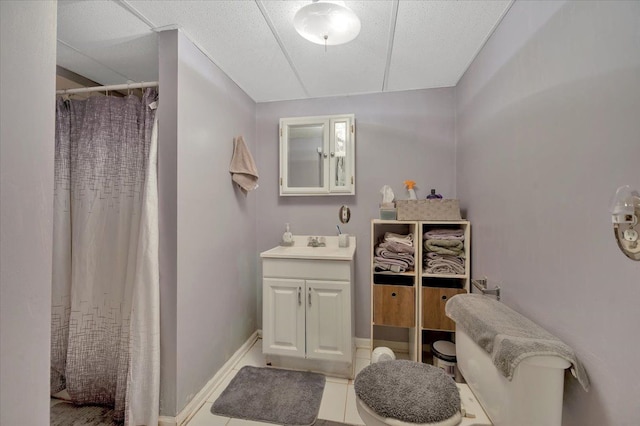 bathroom featuring toilet, vanity, a shower with shower curtain, and tile patterned flooring