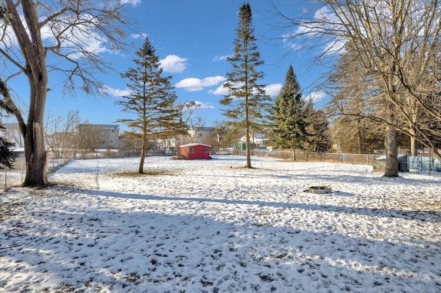 snowy yard with a storage shed