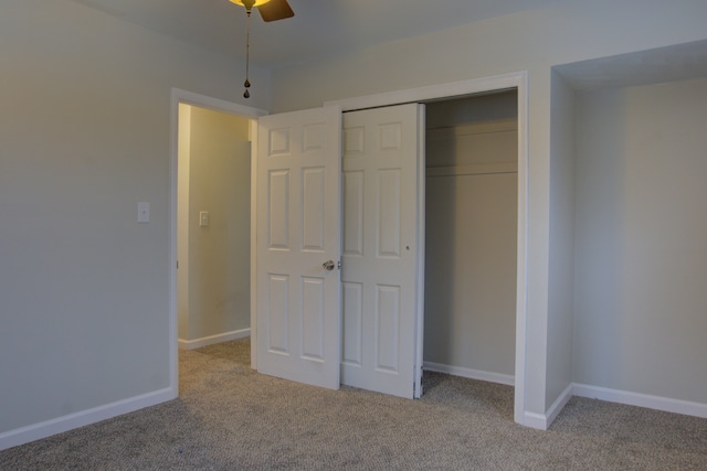 unfurnished bedroom with light carpet, ceiling fan, and a closet