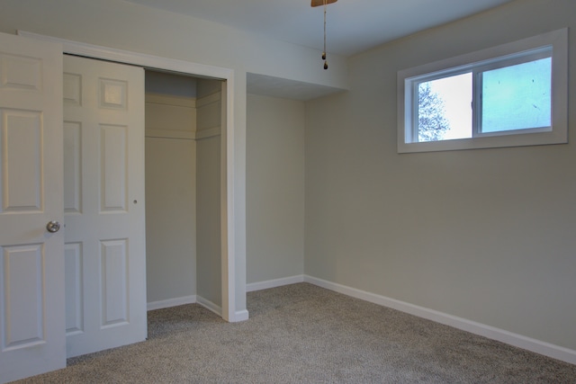 unfurnished bedroom with a closet and light carpet