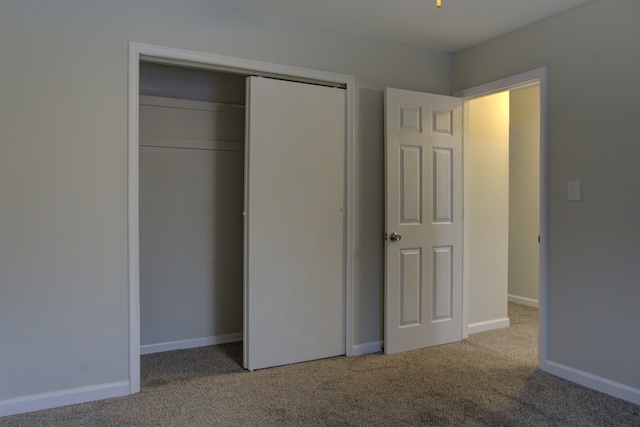 unfurnished bedroom featuring a closet and carpet