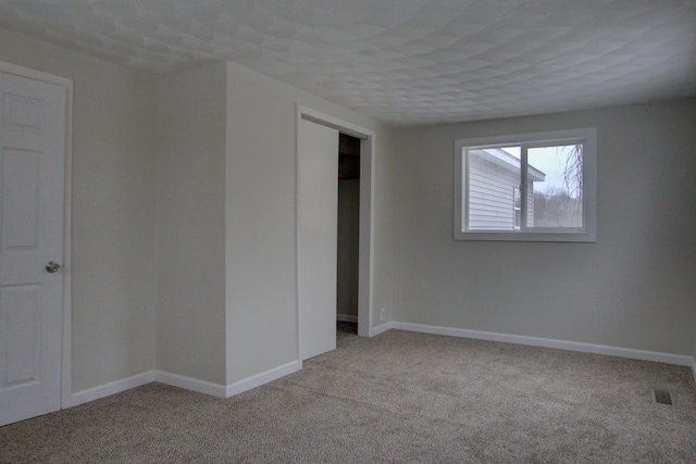 unfurnished room with light colored carpet