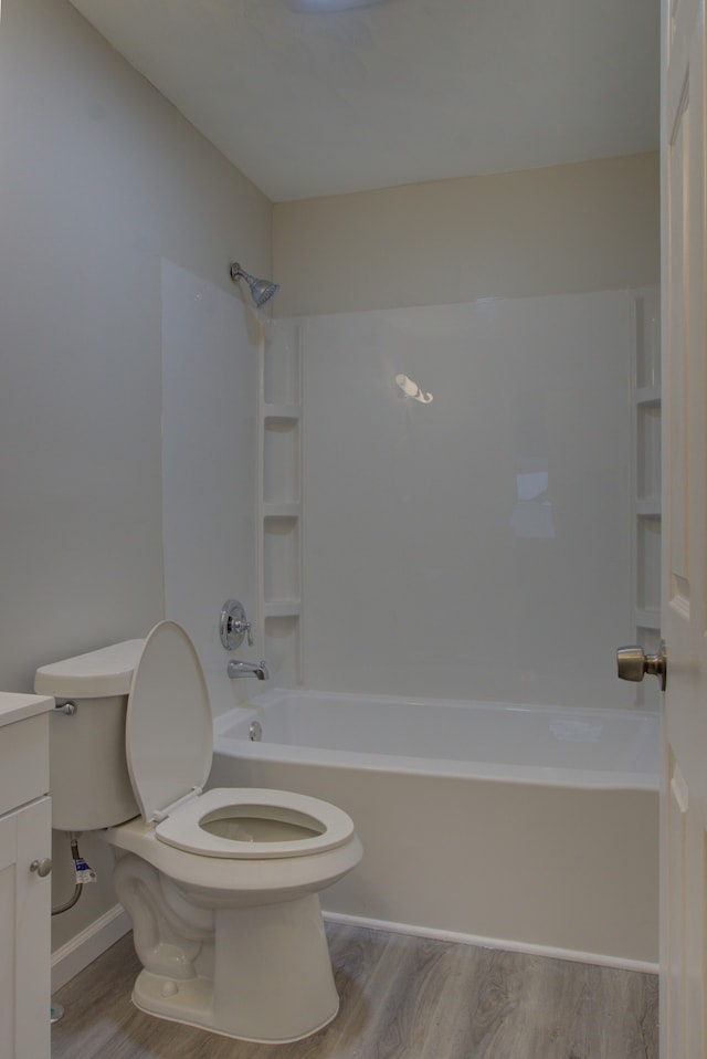 full bathroom featuring vanity, hardwood / wood-style flooring, shower / tub combination, and toilet