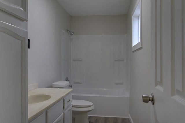 full bathroom featuring shower / bath combination, vanity, hardwood / wood-style flooring, and toilet