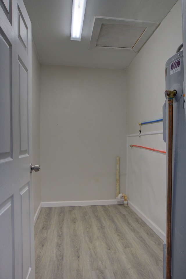 interior space featuring electric water heater and light hardwood / wood-style flooring