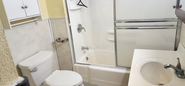 7981 W Main St, Kalamazoo, MI 49009 - full bathroom with bath / shower combo with glass door, sink, tile walls, and toilet