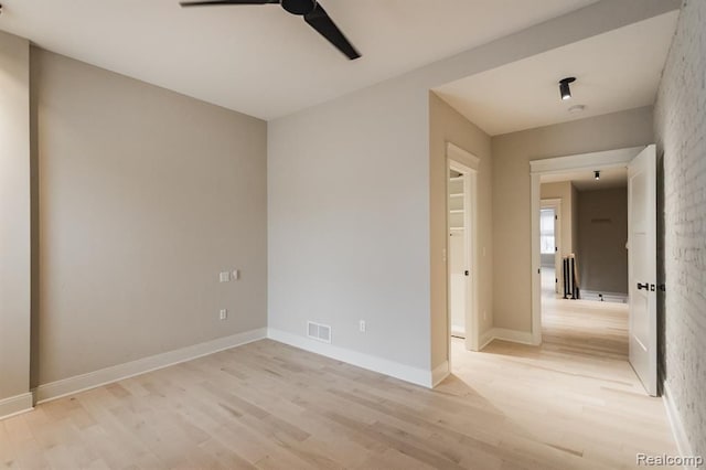 unfurnished room featuring ceiling fan and light hardwood / wood-style flooring