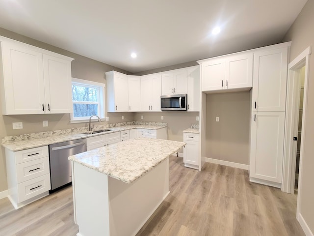 kitchen featuring white cabinets, appliances with stainless steel finishes, and a kitchen island