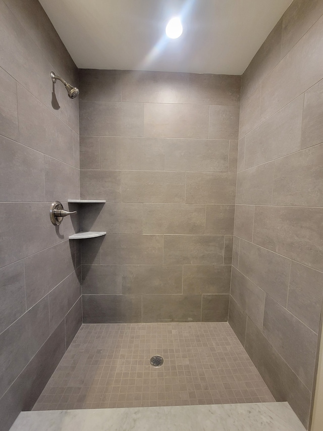 bathroom with tiled shower