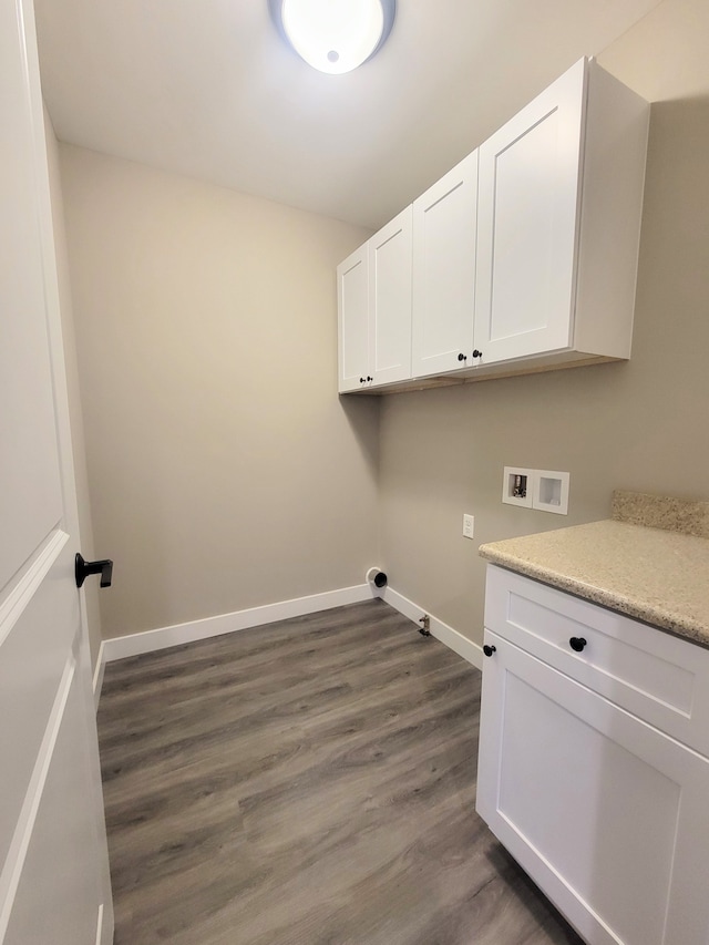 washroom featuring cabinets, washer hookup, and dark hardwood / wood-style flooring