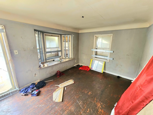 empty room featuring baseboards and a healthy amount of sunlight