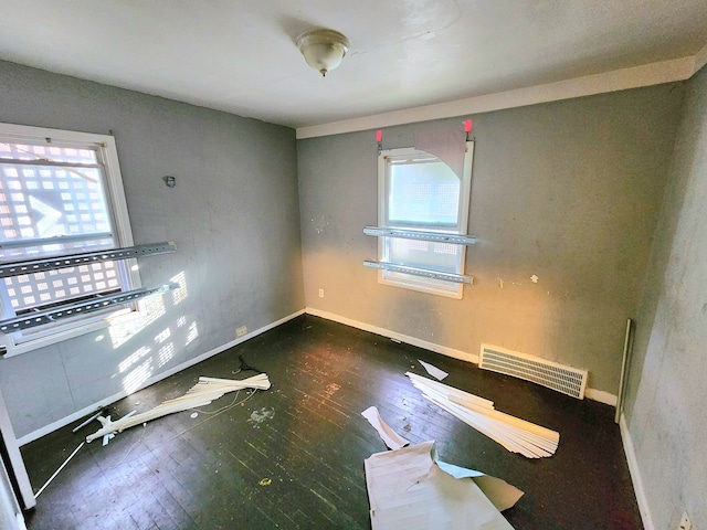 empty room with dark hardwood / wood-style flooring