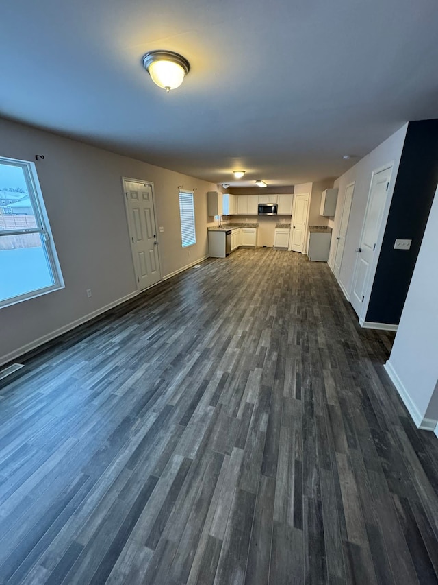 unfurnished living room with dark hardwood / wood-style flooring