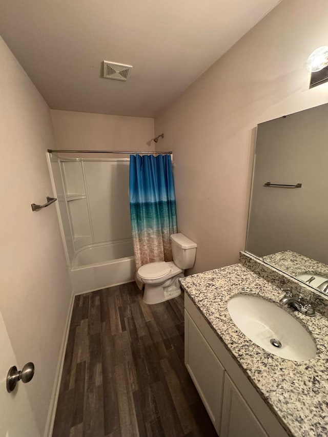 full bathroom featuring shower / bath combo with shower curtain, wood-type flooring, toilet, and vanity