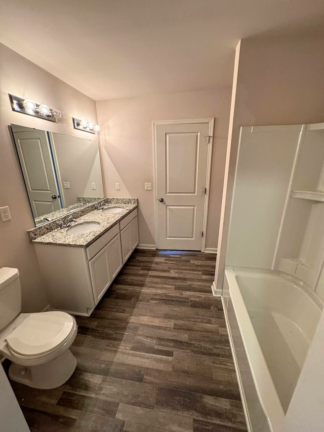 full bathroom featuring shower / bathtub combination, hardwood / wood-style floors, toilet, and vanity