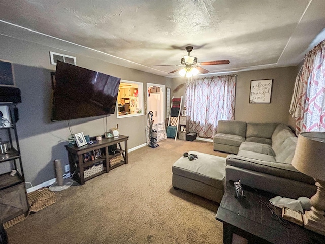 carpeted living room featuring a textured ceiling and ceiling fan