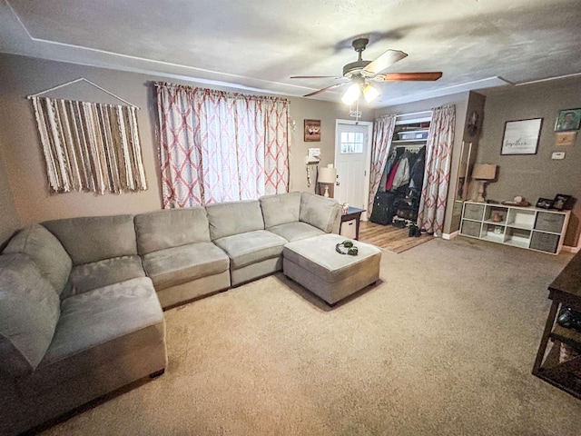 carpeted living room with ceiling fan