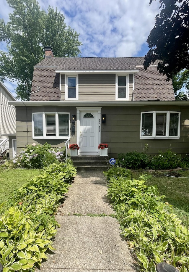 1511 Bernice Ave, Saint Joseph, MI 49085 - view of front of home featuring a chimney and roof with shingles