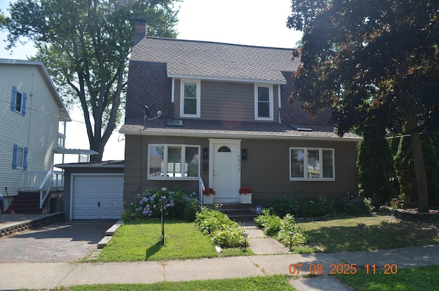 1511 Bernice Ave, Saint Joseph, MI 49085 - view of front of home featuring asphalt driveway, a garage, a front yard, a chimney, and roof with shingles