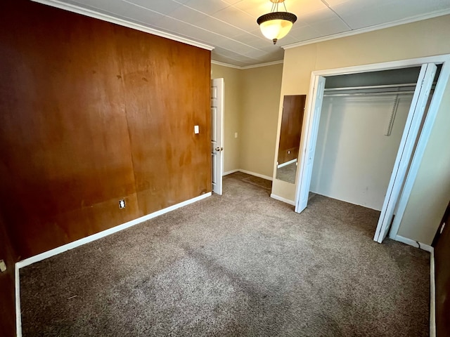 unfurnished bedroom featuring a closet, crown molding, and carpet flooring