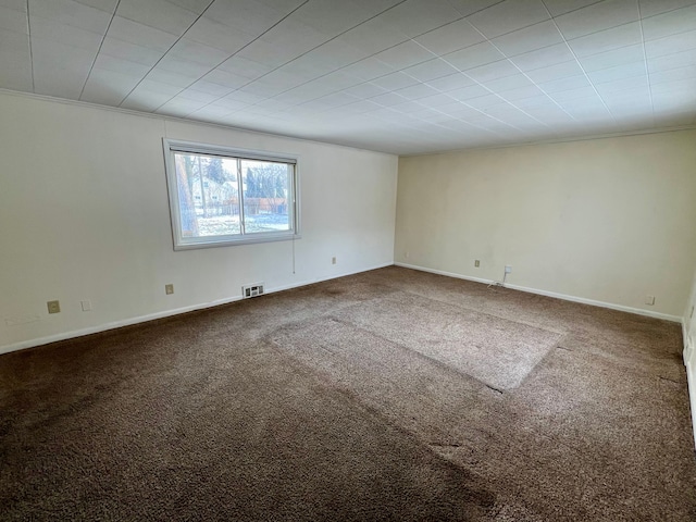 empty room featuring carpet and ornamental molding