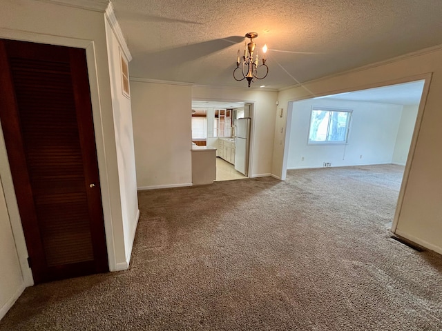 unfurnished living room featuring ornamental molding, a chandelier, light colored carpet, and a textured ceiling