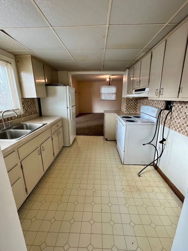 kitchen with washer / dryer, white appliances, a drop ceiling, sink, and backsplash