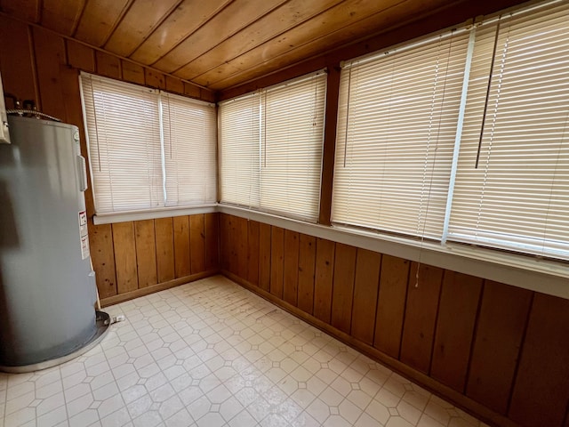 unfurnished sunroom featuring wooden ceiling and water heater