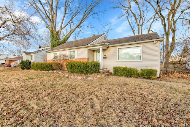 single story home featuring a front yard and fence