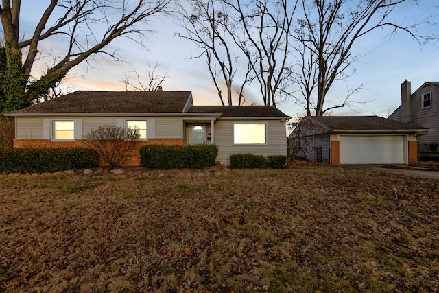 single story home featuring an outdoor structure and an attached garage