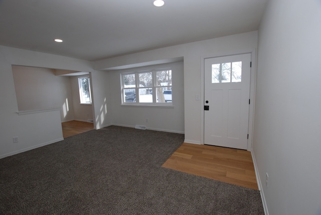 view of carpeted foyer entrance