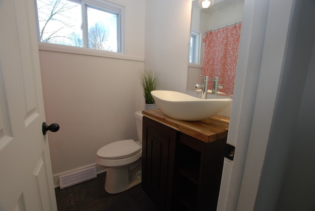 bathroom featuring toilet and vanity