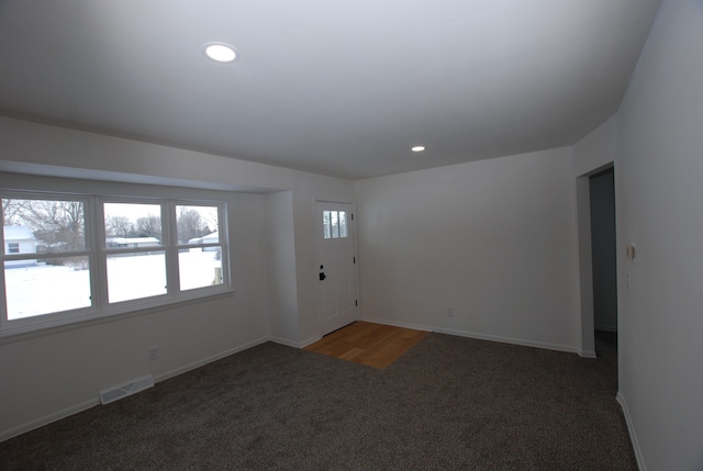 interior space with dark colored carpet