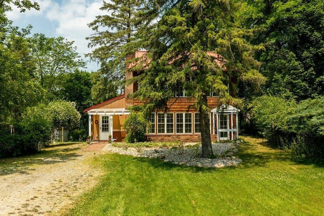 rear view of property featuring a yard