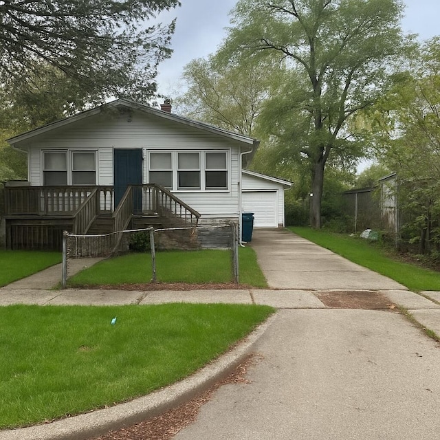 view of front of home featuring a front yard, a detached garage, and a chimney