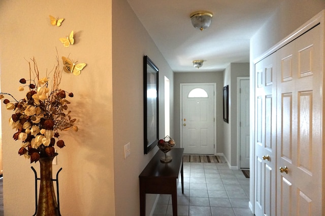 entryway with tile patterned flooring and baseboards