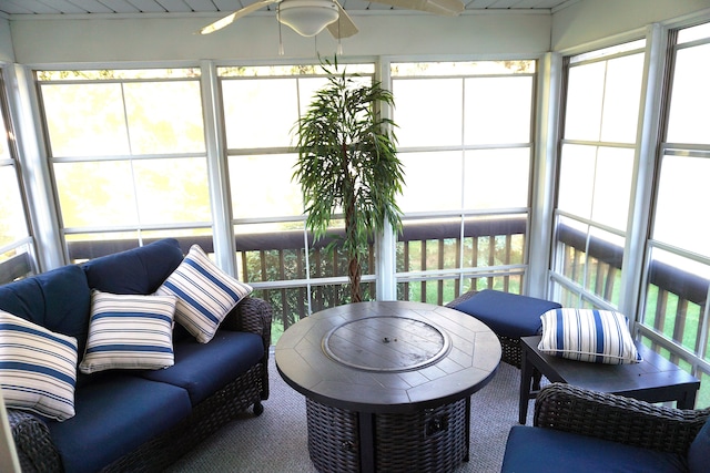 sunroom featuring ceiling fan and a healthy amount of sunlight