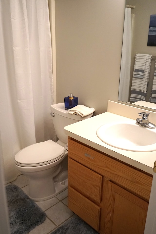 bathroom with tile patterned floors, toilet, and vanity