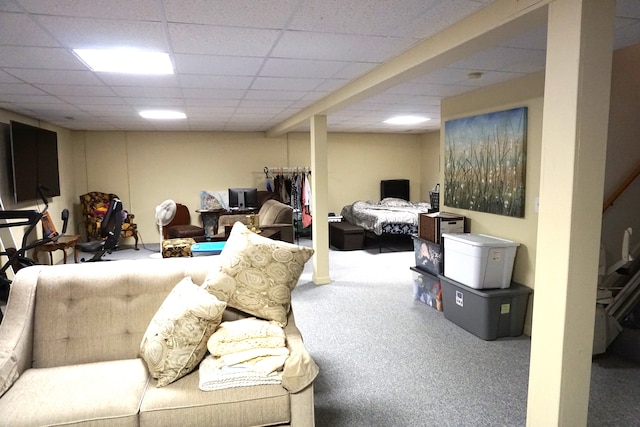 living room featuring a paneled ceiling and carpet