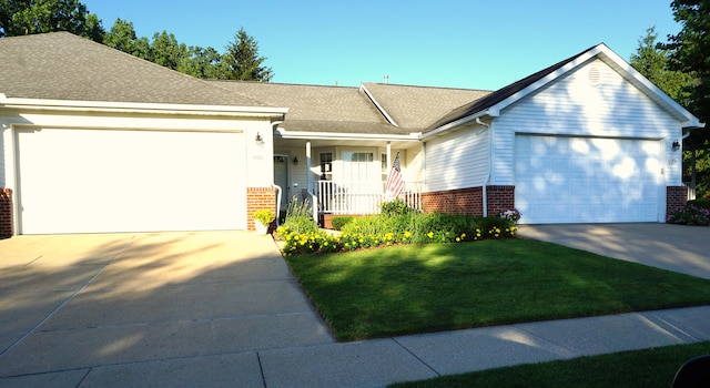 ranch-style house with brick siding, a front lawn, concrete driveway, roof with shingles, and an attached garage